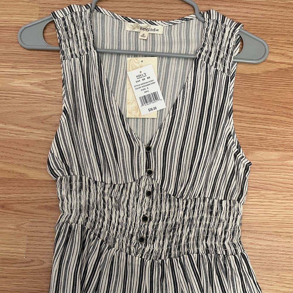 Black and white strapped blouse .